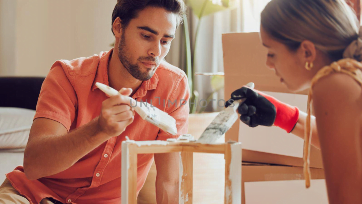 Couple painting wooden furniture white